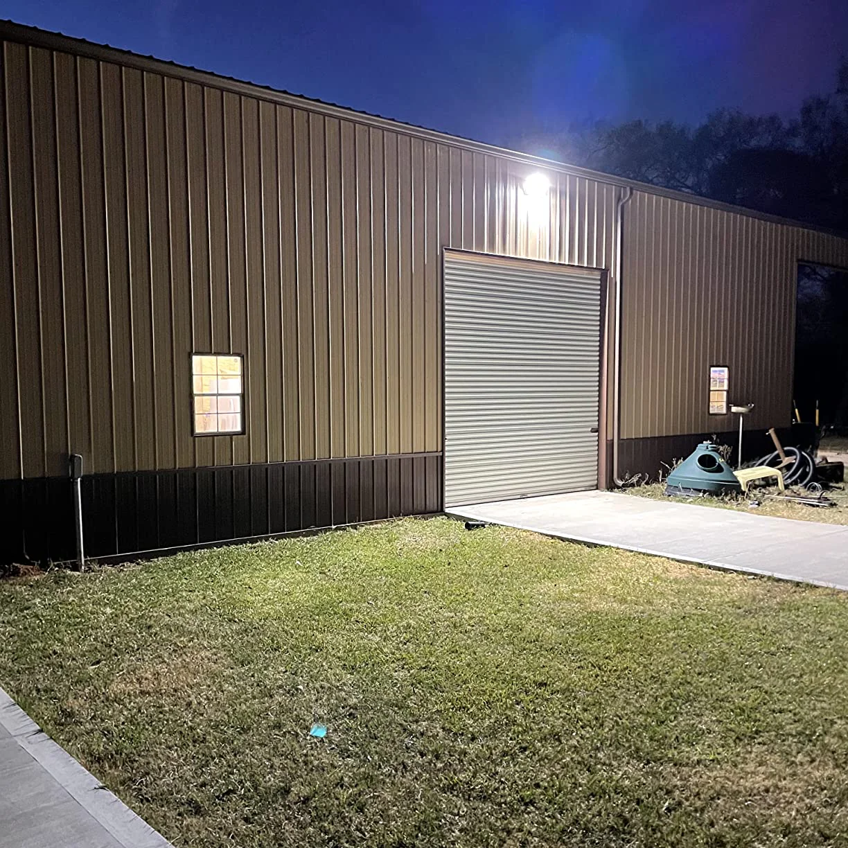 Commercial building exterior with a garage door at night