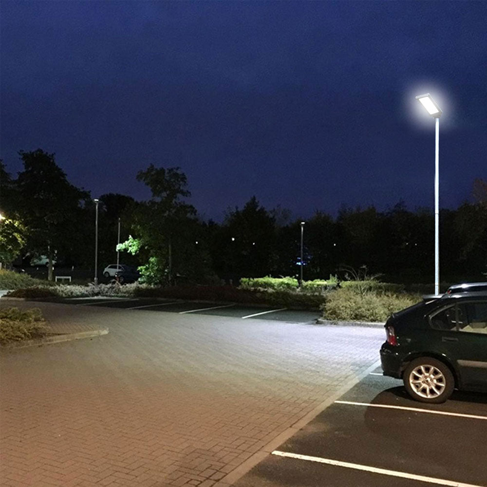 Parking lot at night with a streetlight illuminating the area